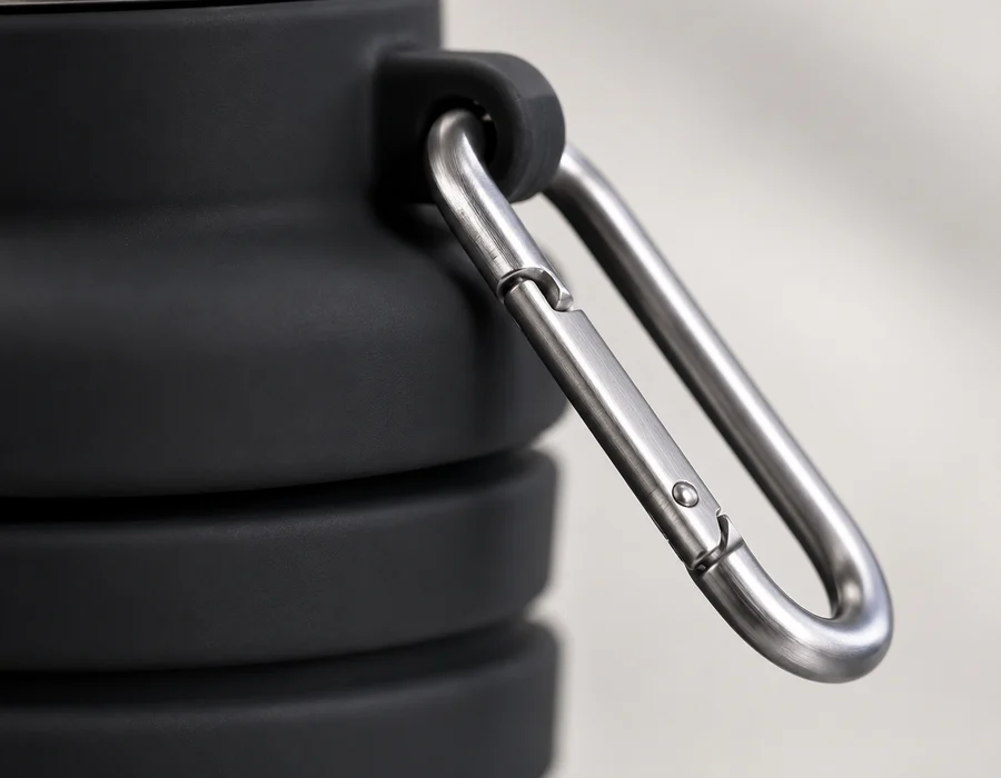 Close view of the stainless steel cap and metal carabiner on a Black collapsible bottle